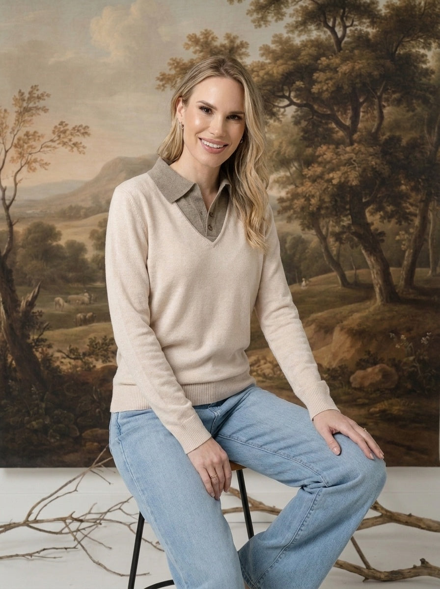 Model wearing a graced ivory and brown collared sweater with a soft knit texture and relaxed fit, paired with jeans.