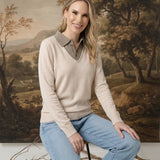 Model wearing a graced ivory and brown collared sweater with a soft knit texture and relaxed fit, paired with jeans.