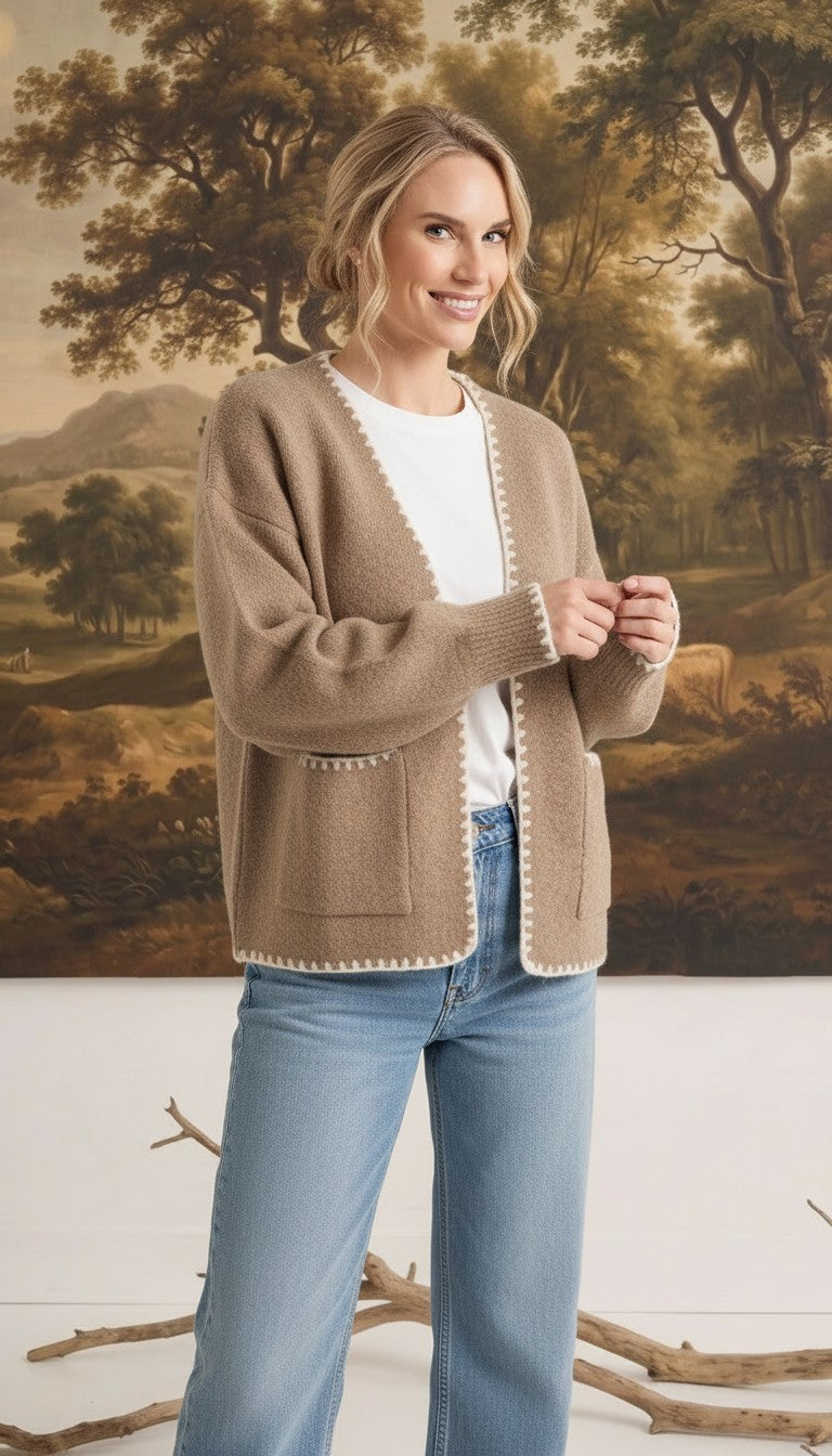 graced The Judy Open Cardigan in tan with white contrast stitching, worn by a model with jeans and a white tee