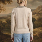 Back view of a woman wearing the graced Kate Collared Sweater in ivory and brown with a soft knit and ribbed hem.