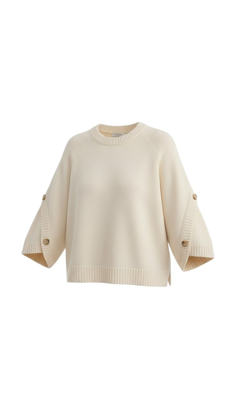 graced The Layla cream knit top with relaxed fit, round neckline, and decorative button details on wide sleeves.