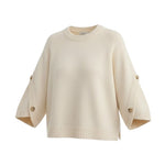 graced The Layla cream knit top with relaxed fit, round neckline, and decorative button details on wide sleeves.