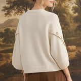 graced The Layla cream knit top with button-detailed sleeves worn by a model in a relaxed fit