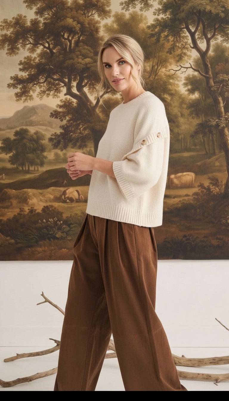 graced Layla cream button sleeve top with a relaxed fit worn by a model with brown trousers