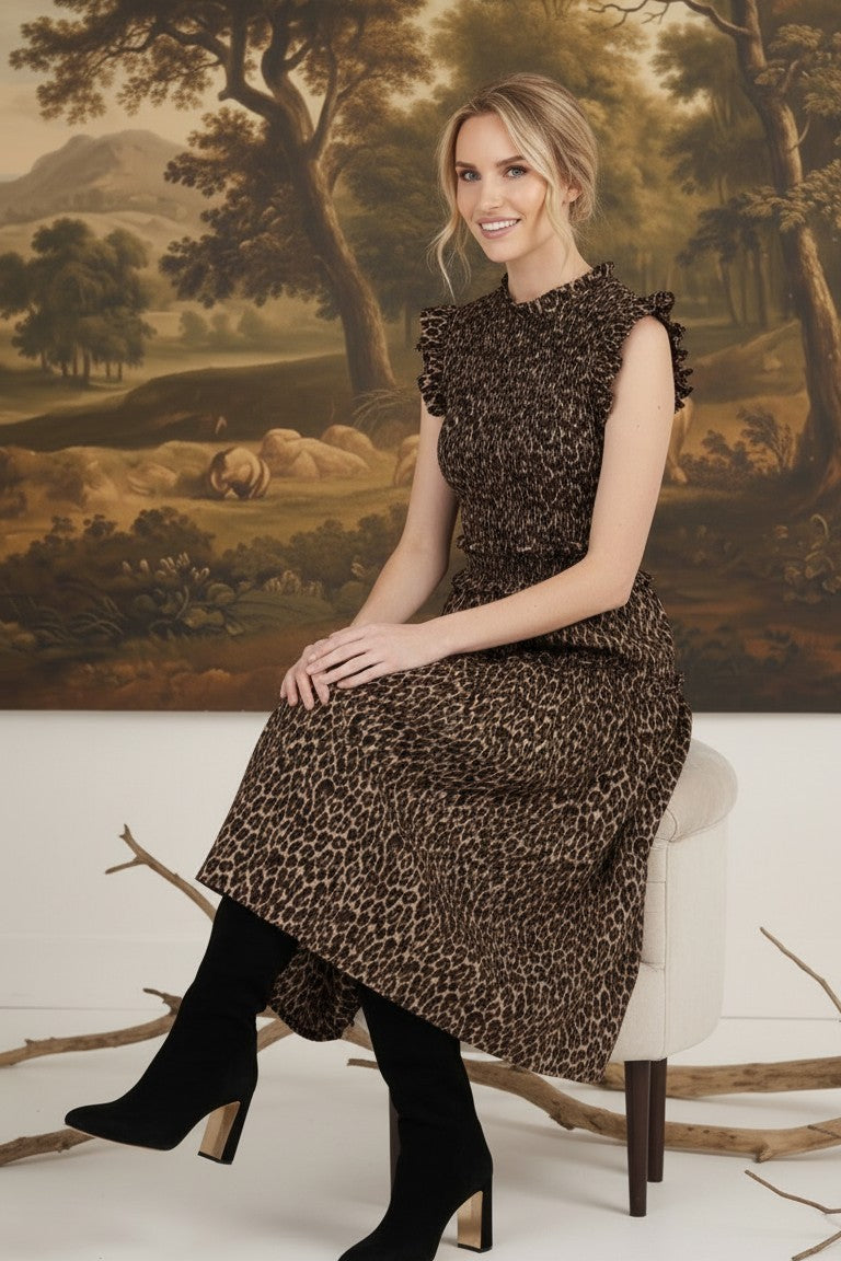 graced Leah sleeveless midi dress in leopard print with smocked bodice and ruffled shoulders worn with black boots