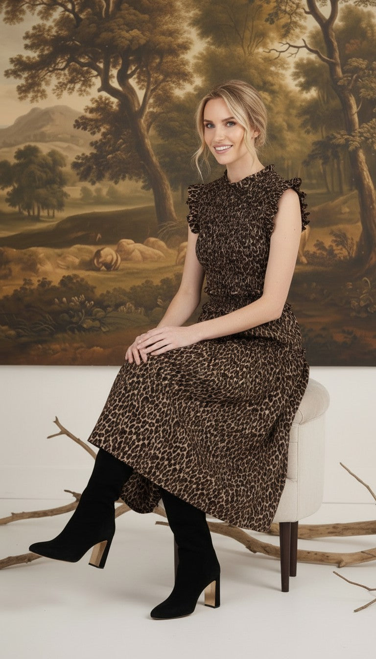 graced Leah sleeveless midi dress in leopard print with smocked bodice and ruffled shoulders worn with black boots