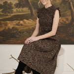 graced Leah sleeveless midi dress in leopard print with smocked bodice and ruffled shoulders worn with black boots