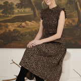 graced Leah sleeveless midi dress in leopard print with smocked bodice and ruffled shoulders worn with black boots