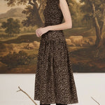 graced Leah sleeveless midi dress in leopard print with smocked waist and ruffled neckline worn by a blonde model