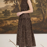 graced Leah sleeveless midi dress in leopard print with smocked waist and ruffled shoulders worn by a blonde model