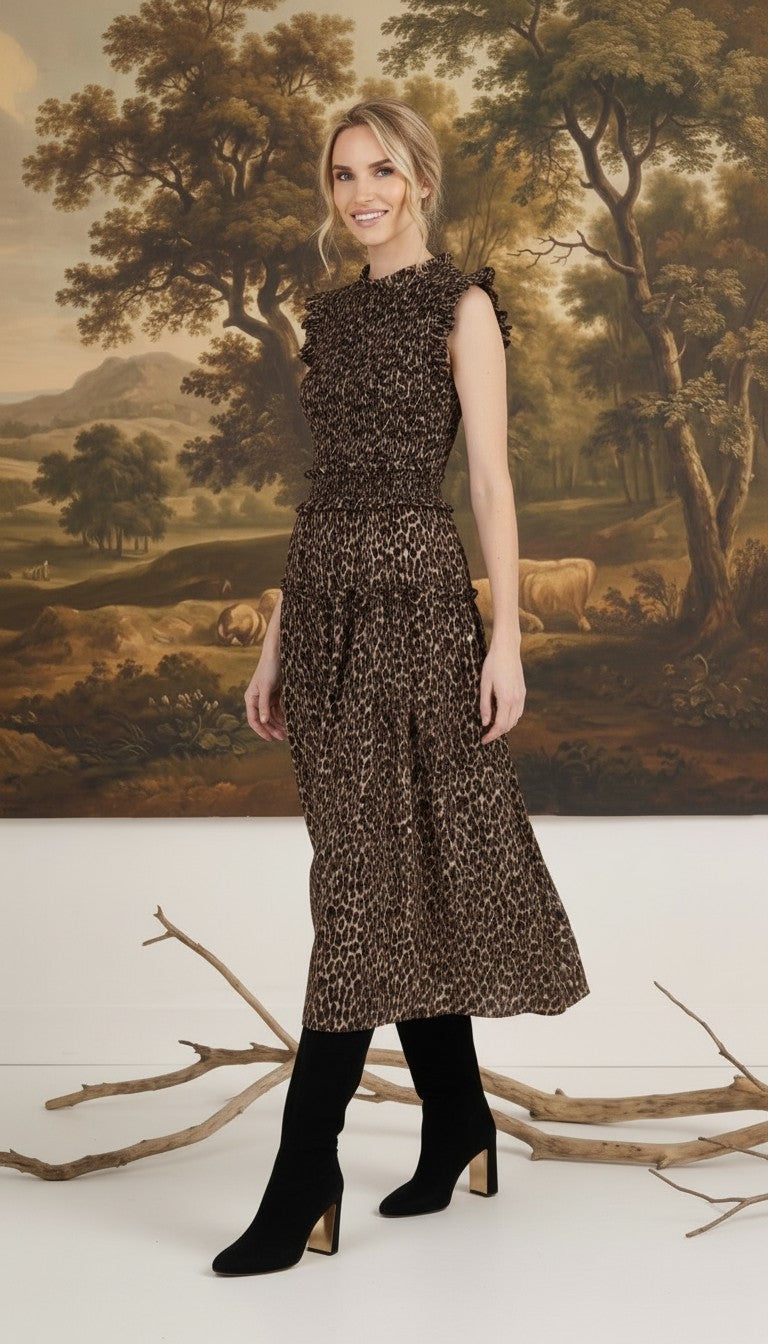 graced Leah sleeveless midi dress in leopard print with a smocked bodice and ruffled shoulders on a model