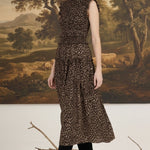 graced Leah sleeveless midi dress in leopard print with a smocked bodice and ruffled shoulders on a model