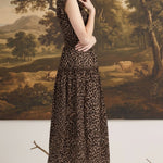 graced Leah sleeveless midi dress in leopard print with a smocked waist and v-neckline worn by a model