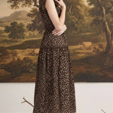 graced Leah sleeveless midi dress in leopard print with a smocked waist and v-neckline worn by a model