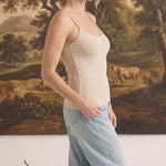 graced light taupe fitted cami with spaghetti straps worn by a woman with light blue jeans