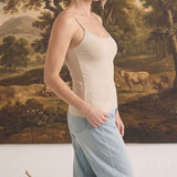 graced light taupe fitted cami with spaghetti straps worn by a woman with light blue jeans