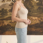 graced light taupe fitted cami with spaghetti straps worn by a woman with light blue jeans