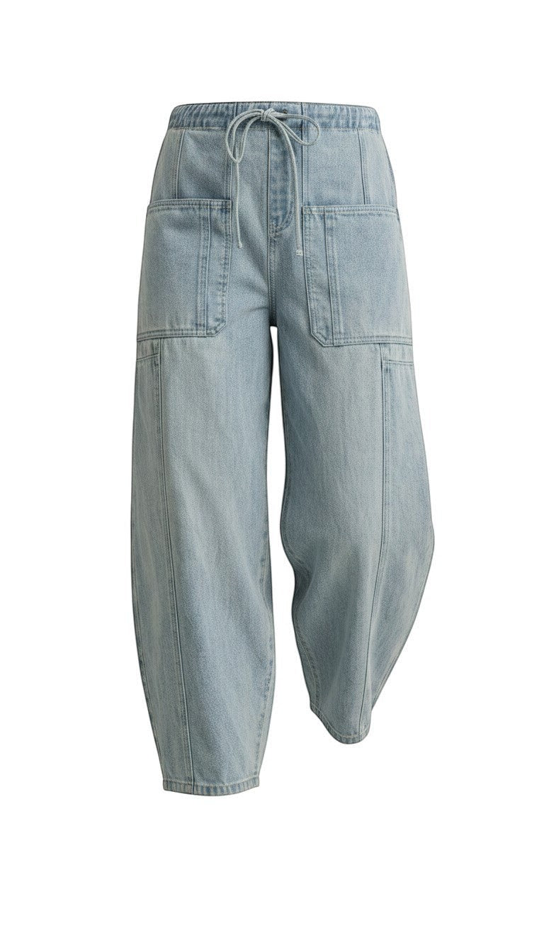 graced light wash denim barrel pants with a relaxed fit, elastic drawstring waist, and large front patch pockets.