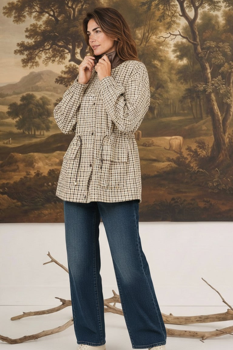 graced The Macy Mock Neck Jacket in a beige and brown gingham print worn by a model with dark blue jeans