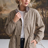graced The Macy Mock Neck Jacket in a beige and brown plaid pattern with a dark brown leather-look collar detail.