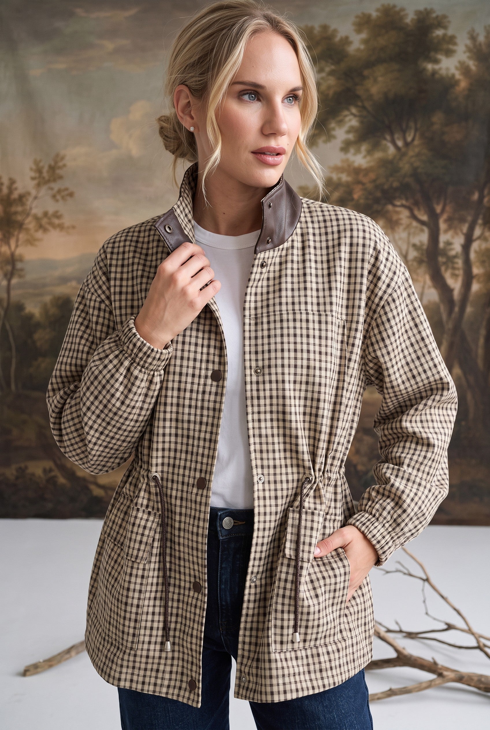 graced The Macy Mock Neck Jacket in a beige and brown plaid pattern with a dark brown leather-look collar detail.