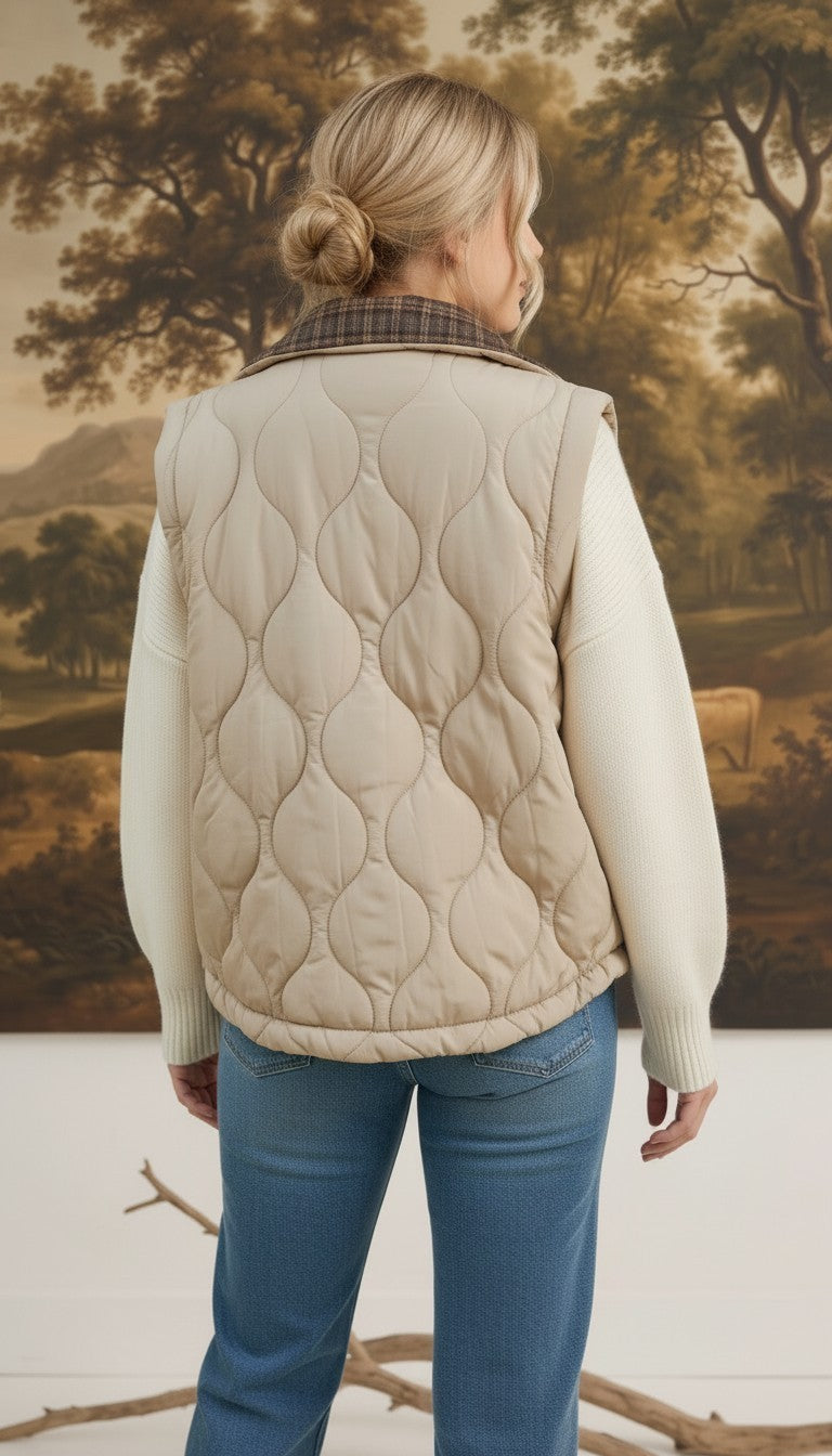 Back view of a woman wearing a graced Madilynne beige quilted vest with a plaid collar over a white sweater.