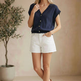 Navy sleeveless button-down top from in February, featuring a classic collar and relaxed fit, perfect for casual or office wear.