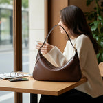 Melie Bianco Nicolette shoulder bag in espresso with sleek design and adjustable strap on a neutral background.