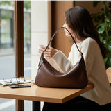 Melie Bianco Nicolette shoulder bag in espresso with sleek design and adjustable strap on a neutral background.