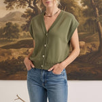 graced olive green sleeveless cotton button-down top worn by a model with blue jeans