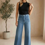 JBD Patch Pocket Wide Leg Jeans showing high-waisted design, patch pockets on the back, and wide-leg cut in denim fabric.