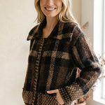 graced plaid button-down cardigan in brown and black with a structured collar and front pockets on a smiling model