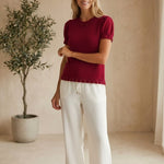 Red knit scallop trim puff sleeve top by Camellia, featuring ruffled details and a stylish, feminine design.