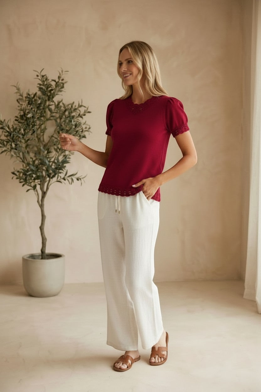 Red Camellia knit top with scallop trim and puff sleeves, featuring a stylish, feminine design.