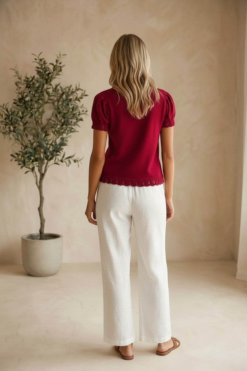 Red Camellia knit top with scallop trim and puff sleeves, featuring a stylish and feminine design.
