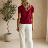 Red Camellia knit top with scallop trim and puff sleeves, featuring a stylish and feminine design.