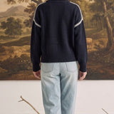 graced The Sheila Sweater in navy blue with white crochet-style shoulder detailing, worn with light wash jeans