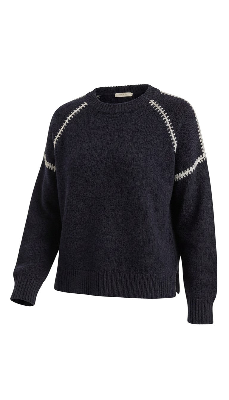 graced The Sheila Sweater in navy blue with cream-colored whipstitch detailing along the raglan sleeves