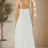 Lovestitch shirred tie-shoulder maxi dress with flowing fabric and elegant design, perfect for summer or casual wear.