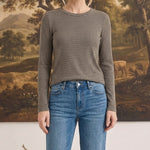 graced long sleeve top with horizontal stripes in olive and white worn by a woman with blue jeans