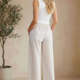 Allie Rose striped smock waist pants featuring vertical black and white stripes and a relaxed fit, casual and stylish bottoms.