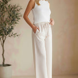 Allie Rose striped smock waist pants with a relaxed fit and vertical blue, white, and beige stripes, shown on a model.