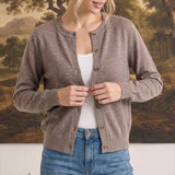 graced crew neck button down cardigan in taupe worn by a woman over a white tank top and blue jeans