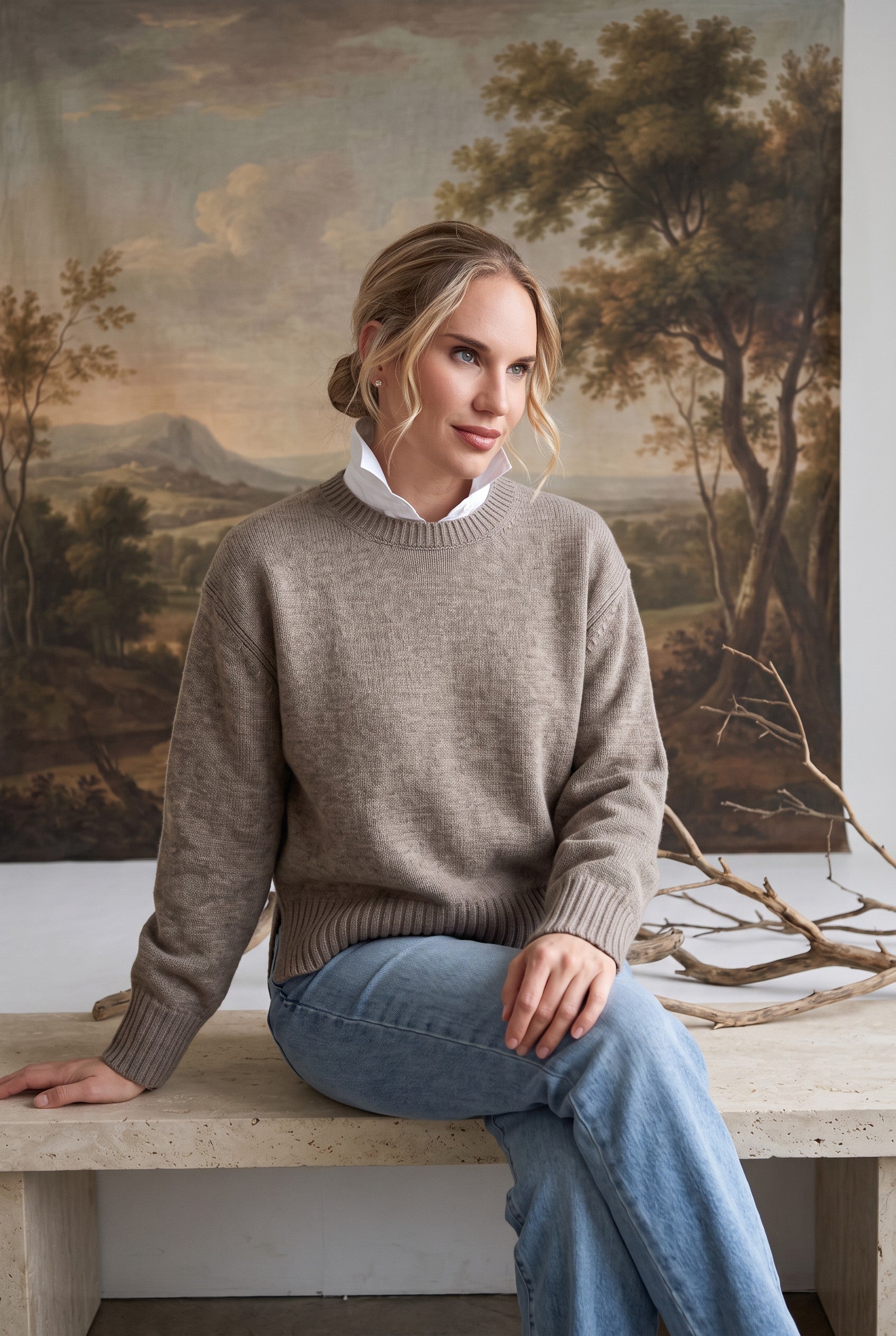 graced crew neck sweater in taupe worn by a woman with a white collared shirt underneath and light blue jeans