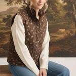 graced The Teagan Quilted Vest in brown floral cotton with a button-front closure worn over a cream sweater.