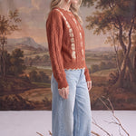 graced terracotta cable knit sweater with floral embroidery worn by a blonde model with light wash wide leg jeans