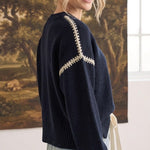 graced The Sheila Sweater in navy blue with cream contrast stitching on the shoulders worn by a smiling model