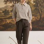 graced Tracy striped polo top with lace collar detail worn by a model with brown trousers in a studio setting