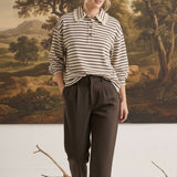 graced Tracy striped polo top with lace collar detail worn by a model with brown trousers in a studio setting
