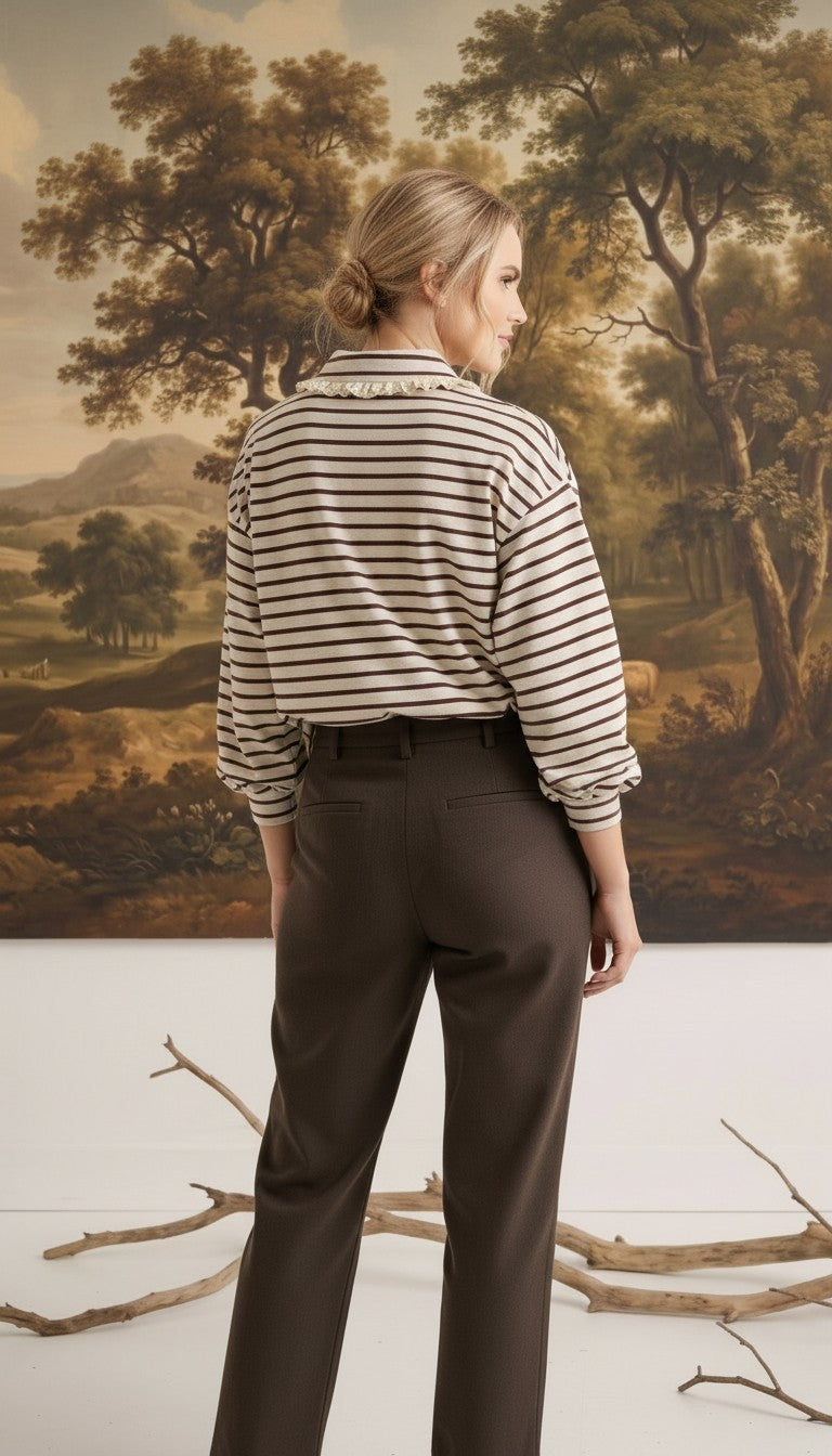 graced Tracy striped polo top with lace collar trim worn by a model with dark trousers in a studio setting